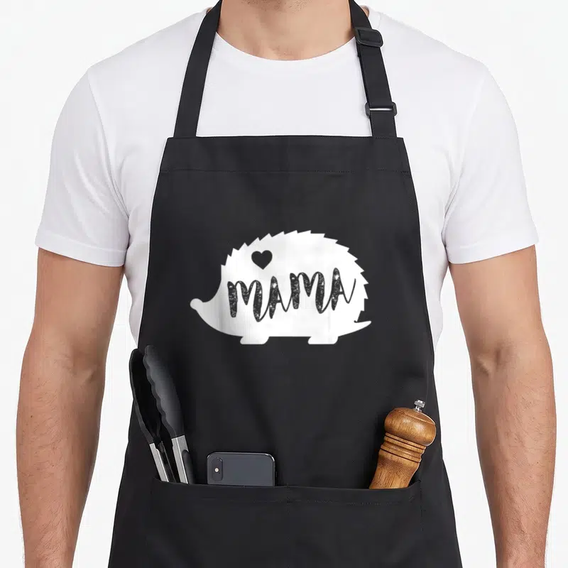 Mama hedgehog mother's day aprons - White hedgehog silhouette with grey MAMA text and heart — shown on a black cotton canvas apron against a white background