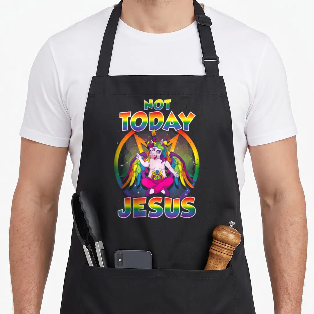 Baphomet unicorn apron - Cartoon winged unicorn in rainbow circle with NOT TODAY JESUS text — shown on a black cotton canvas apron against a white background