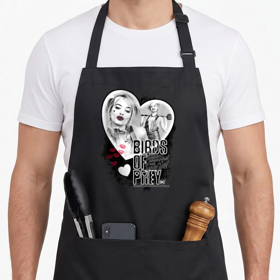 Bird prey vehicle apron - Harley Quinn photos in a heart with stacked text and red lips on white and black background — shown on a black cotton canvas apron against a white background