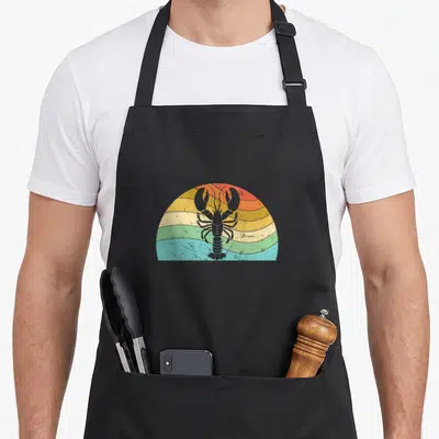 Peterson lobster apron - Grey lobster silhouette on red orange yellow green blue striped semi-circle background — shown on a black cotton canvas apron against a white background