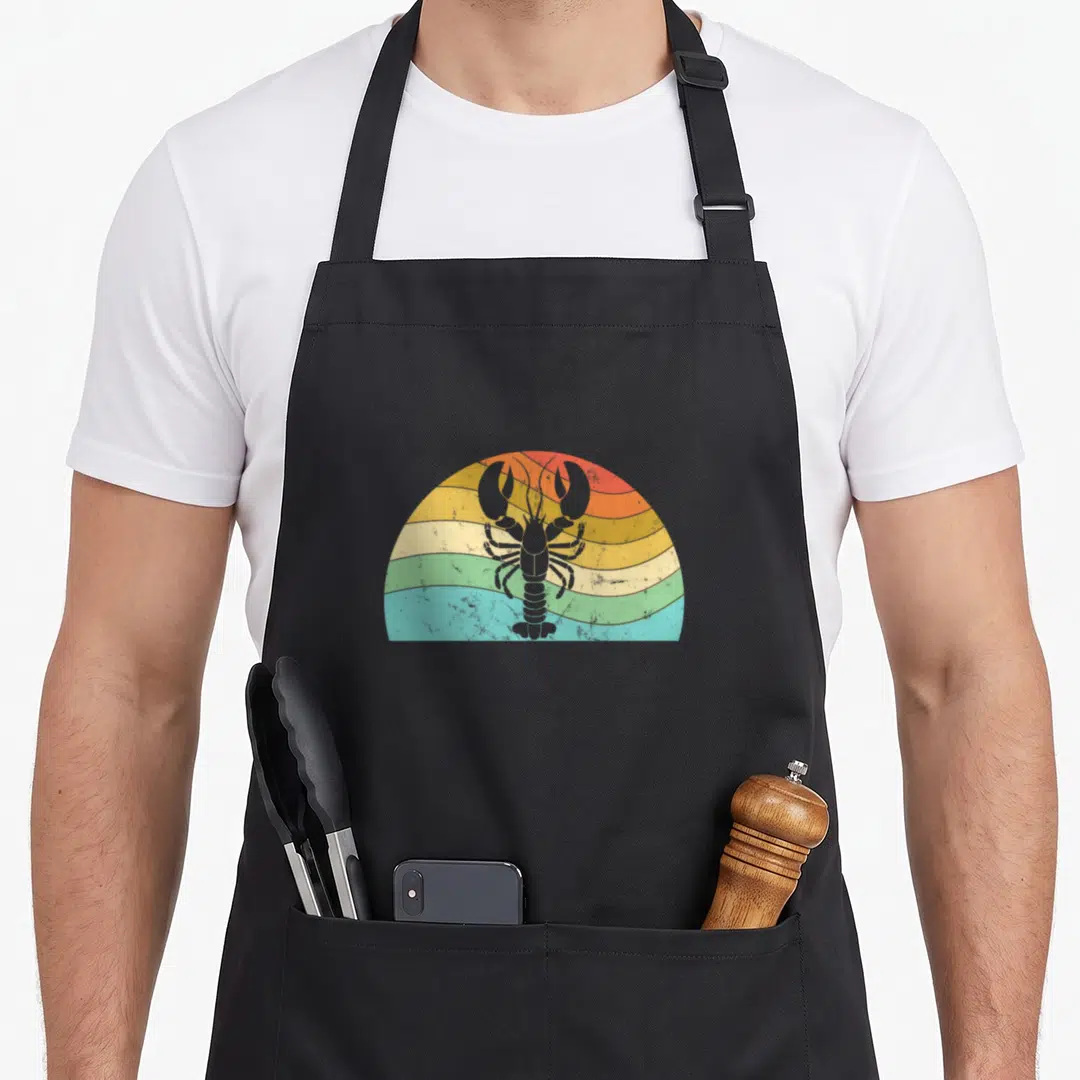 Peterson lobster apron - Grey lobster silhouette on red orange yellow green blue striped semi-circle background — shown on a black cotton canvas apron against a white background