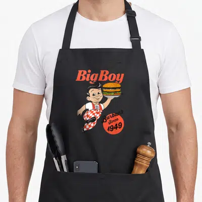 Bob los angele apron - Big Boy mascot holding burger with Burbank Since 1949 text — shown on a black cotton canvas apron against a white background