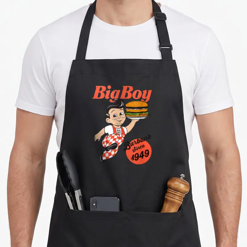 Bob los angele apron - Big Boy mascot holding burger with Burbank Since 1949 text — shown on a black cotton canvas apron against a white background