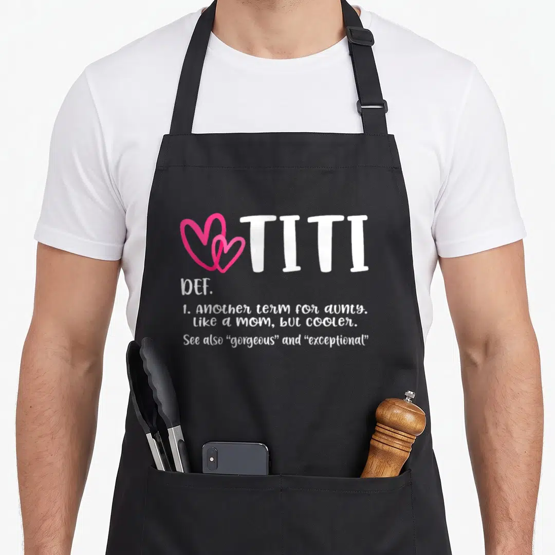 Titi grandma apron - Two pink hearts next to white TITI text with definition lines below — shown on a black cotton canvas apron against a white background