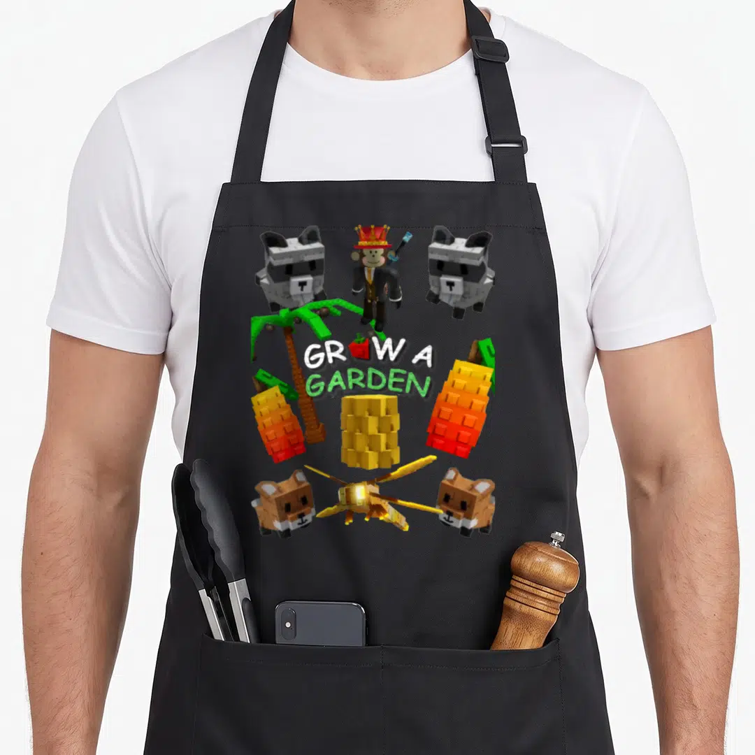 Grow game aprons - Pixel art GROW A GARDEN text surrounded by blocky monkey, raccoons, and plants — shown on a black cotton canvas apron against a white background