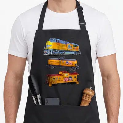 Freight boy train apron - Vertical stack of Union Pacific 9019 locomotive, UP 8665 tanker, and 13605 caboose in yellow — shown on a black cotton canvas apron against a white background