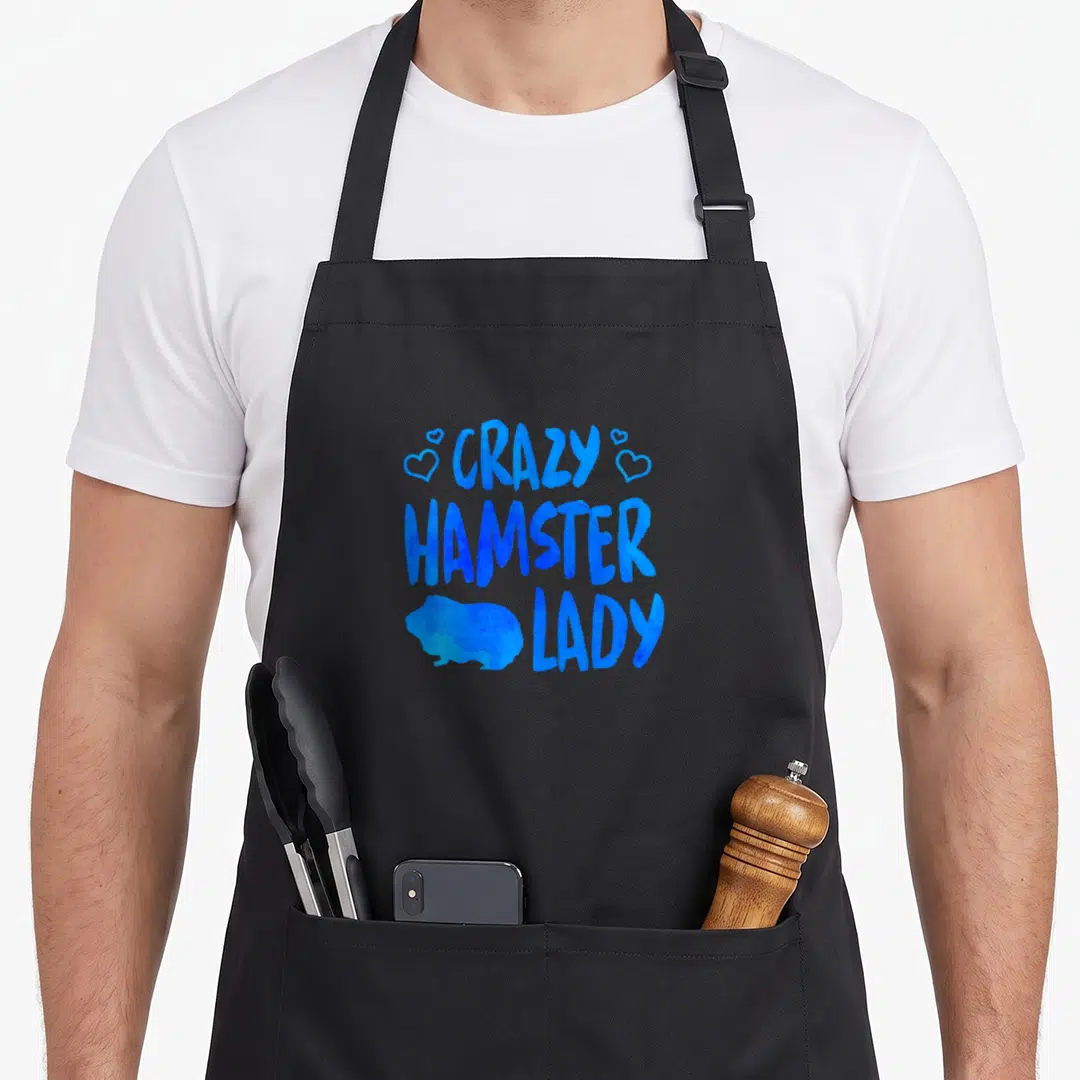 Cute hamster animal apron - Blue stacked text CRAZY HAMSTER LADY with hamster silhouette and four hearts — shown on a black cotton canvas apron against a white background