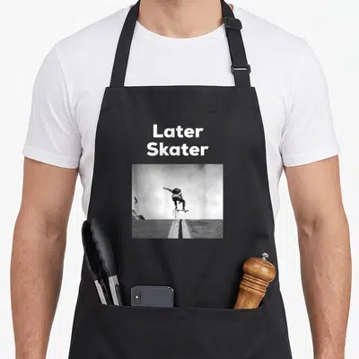 Later pipe mom apron - White Later Skater text above black and white photo of jumping skateboarder — shown on a black cotton canvas apron against a white background