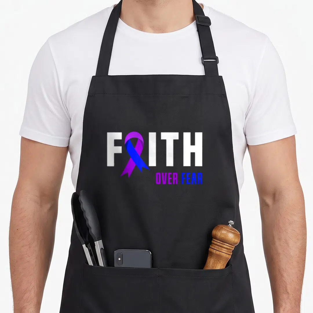 Fighter faith aprons - FAITH OVER FEAR text with purple blue ribbon replacing — shown on a black cotton canvas apron against a white background