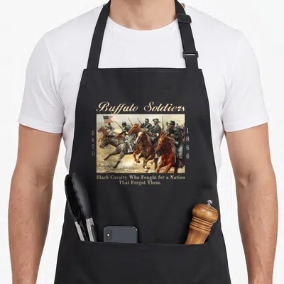 African military apron - Buffalo Soldiers painting with ESTD 1866 text and Black Cavalry quote in beige and brown — shown on a black cotton canvas apron against a white background