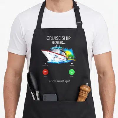 Cruise must apron - Smartphone call screen graphic with cruise ship and accept decline buttons in red green and white — shown on a black cotton canvas apron against a white background