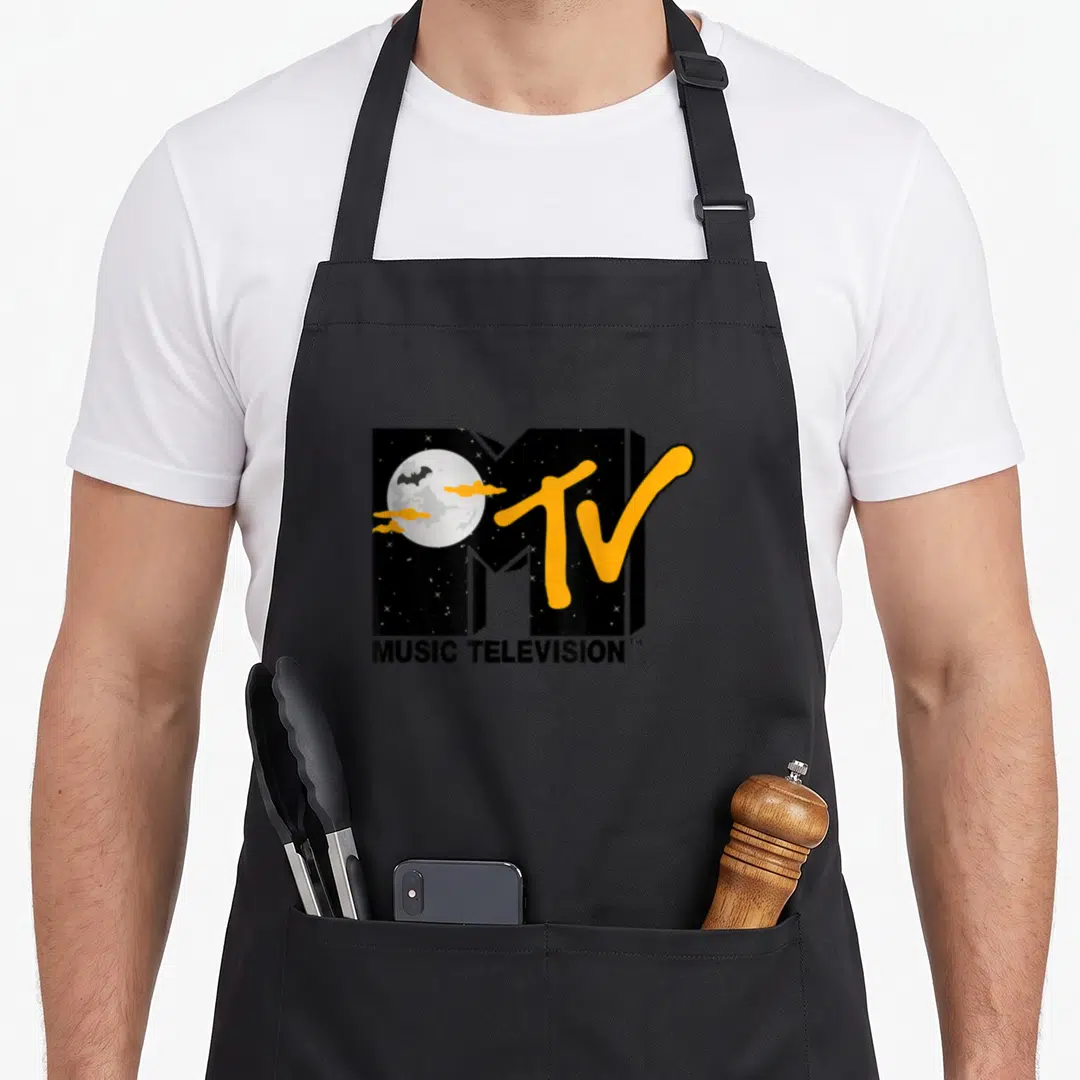 Mtv halloween apron - MTV logo with moon bat clouds inside M orange TV script MUSIC TELEVISION text below cartoon style — shown on a black cotton canvas apron against a white background