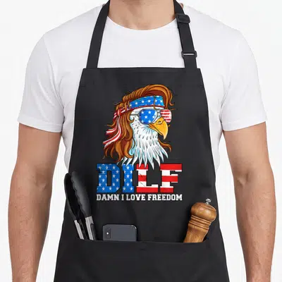 Dilf eagles grill apron - Cartoon eagle with brown hair, star-spangled sunglasses, and DILF text — shown on a black cotton canvas apron against a white background