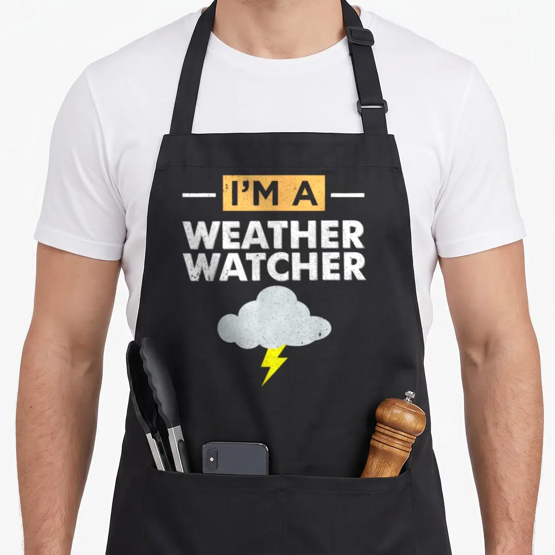 Watcher meteorologist apron - Stacked text I'M A WEATHER WATCHER above distressed cloud and yellow lightning bolt — shown on a black cotton canvas apron against a white background