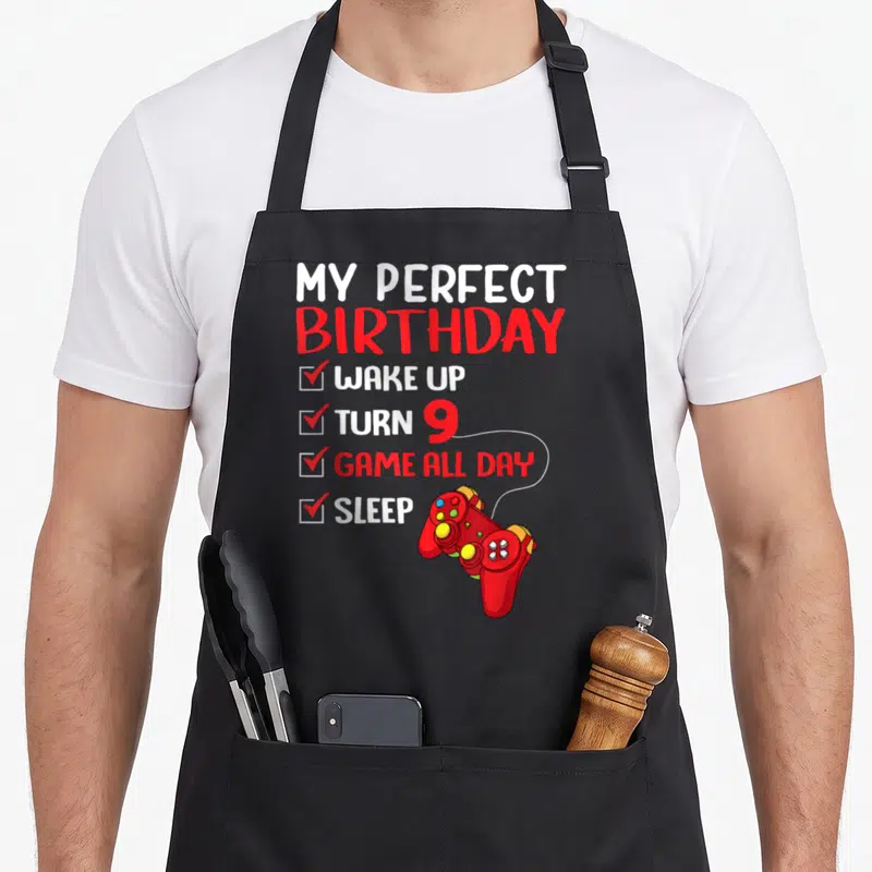 Perfect gaming aprons - My Perfect Birthday Wake Up Turn 9 Game All Day Sleep checklist with red game controller — shown on a black cotton canvas apron against a white background