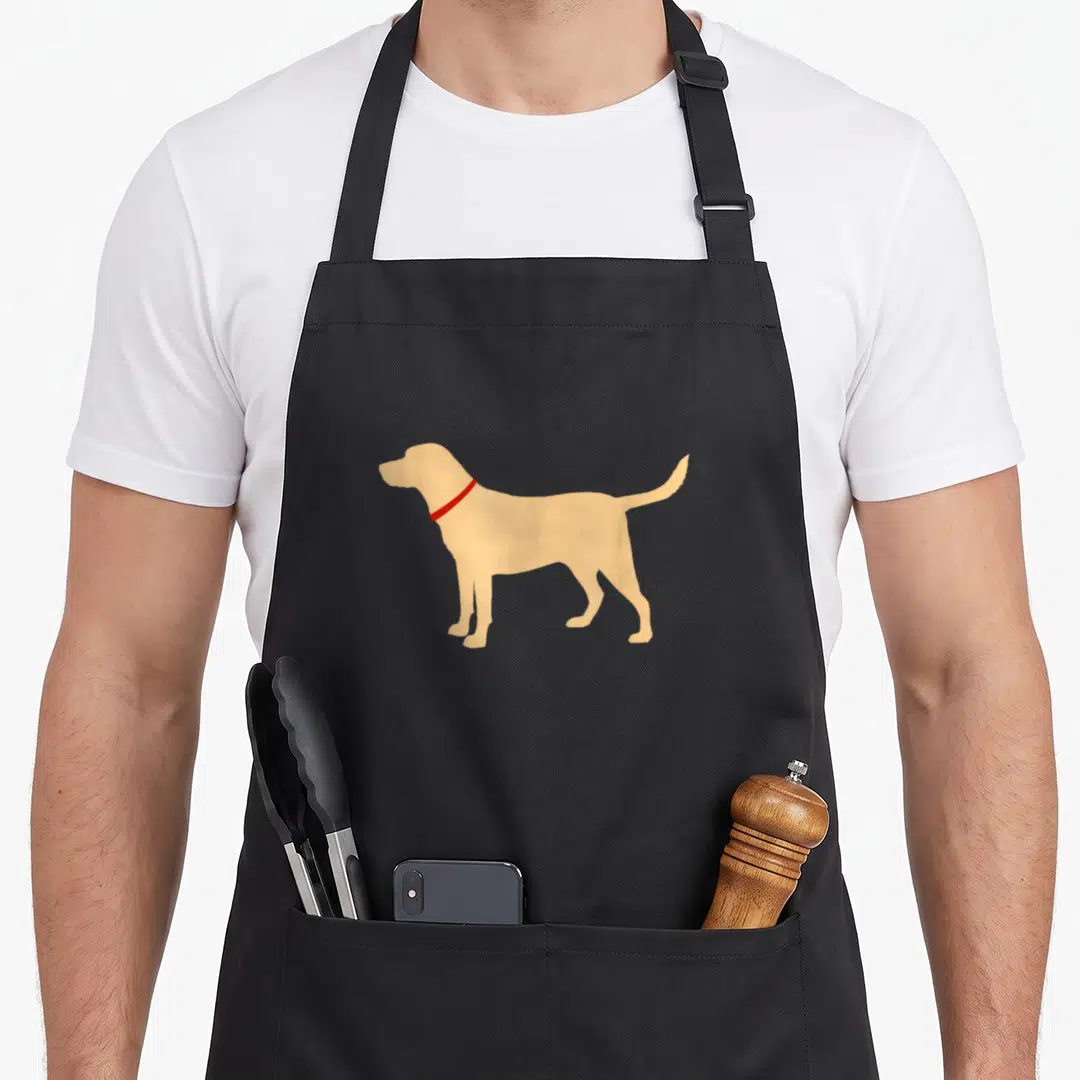 Vintage retriever labrador apron - Tan dog silhouette with red collar on black bib — shown on a black cotton canvas apron against a white background