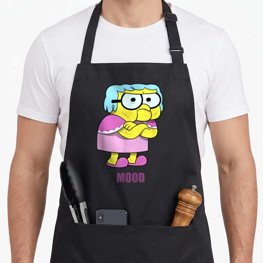 Gramma alice apron - Cartoon woman with crossed arms and purple MOOD text — shown on a black cotton canvas apron against a white background
