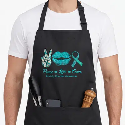 Peace anxiety apron - Teal peace sign, glitter lips, and awareness ribbon with 'Peace Love Cure' text — shown on a black cotton canvas apron against a white background