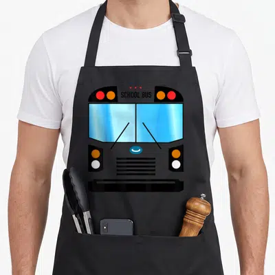 Costume omnibus apron - Front view of grey school bus with blue windows and centered SCHOOL BUS text — shown on a black cotton canvas apron against a white background