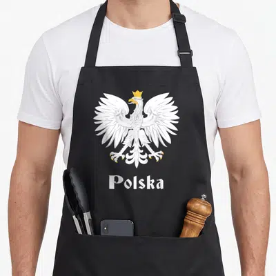 Poland polish aprons - Crowned white eagle illustration above white Polska text on canvas fabric — shown on a black cotton canvas apron against a white background