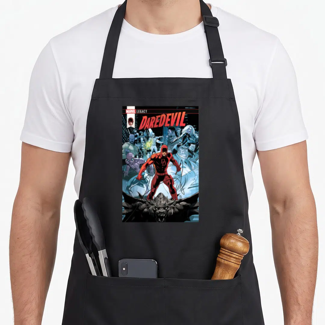 Daredevil cover apron - MARVEL LEGACY DAREDEVIL text above red hero, Spider-Man, monster, and crowd in blue grey — shown on a black cotton canvas apron against a white background