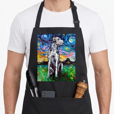 Merle dog apron - Seated merle dog on green grass under swirling blue yellow and black starry night sky art — shown on a black cotton canvas apron against a white background