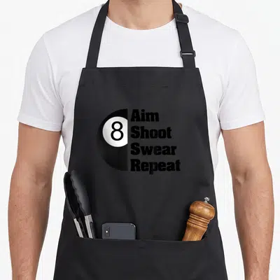 Ball pool player billiards apron - Half circle 8-ball next to stacked Aim Shoot Swear Repeat text in black and white — shown on a black cotton canvas apron against a white background