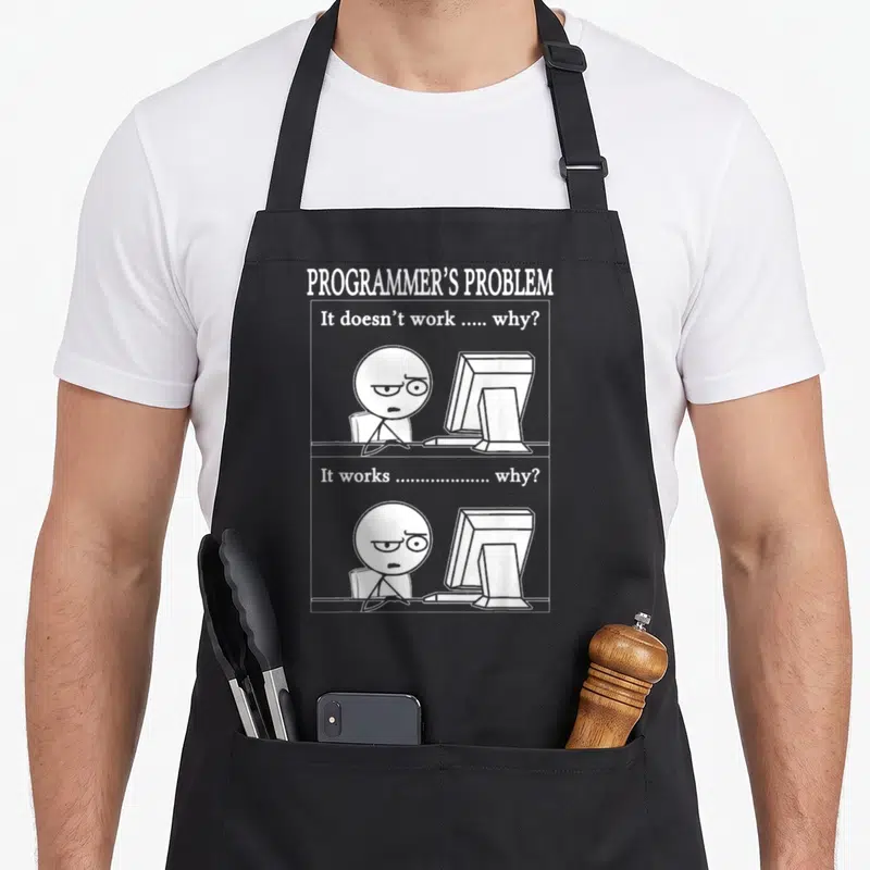Programmer developer problems apron - White line art of stick figure at computer with It doesn't work why text — shown on a black cotton canvas apron against a white background