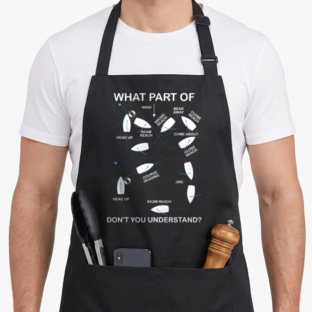 Board sailor apron - Diagram of sailboat positions connected by dotted lines with sailing terms and sarcastic text — shown on a black cotton canvas apron against a white background