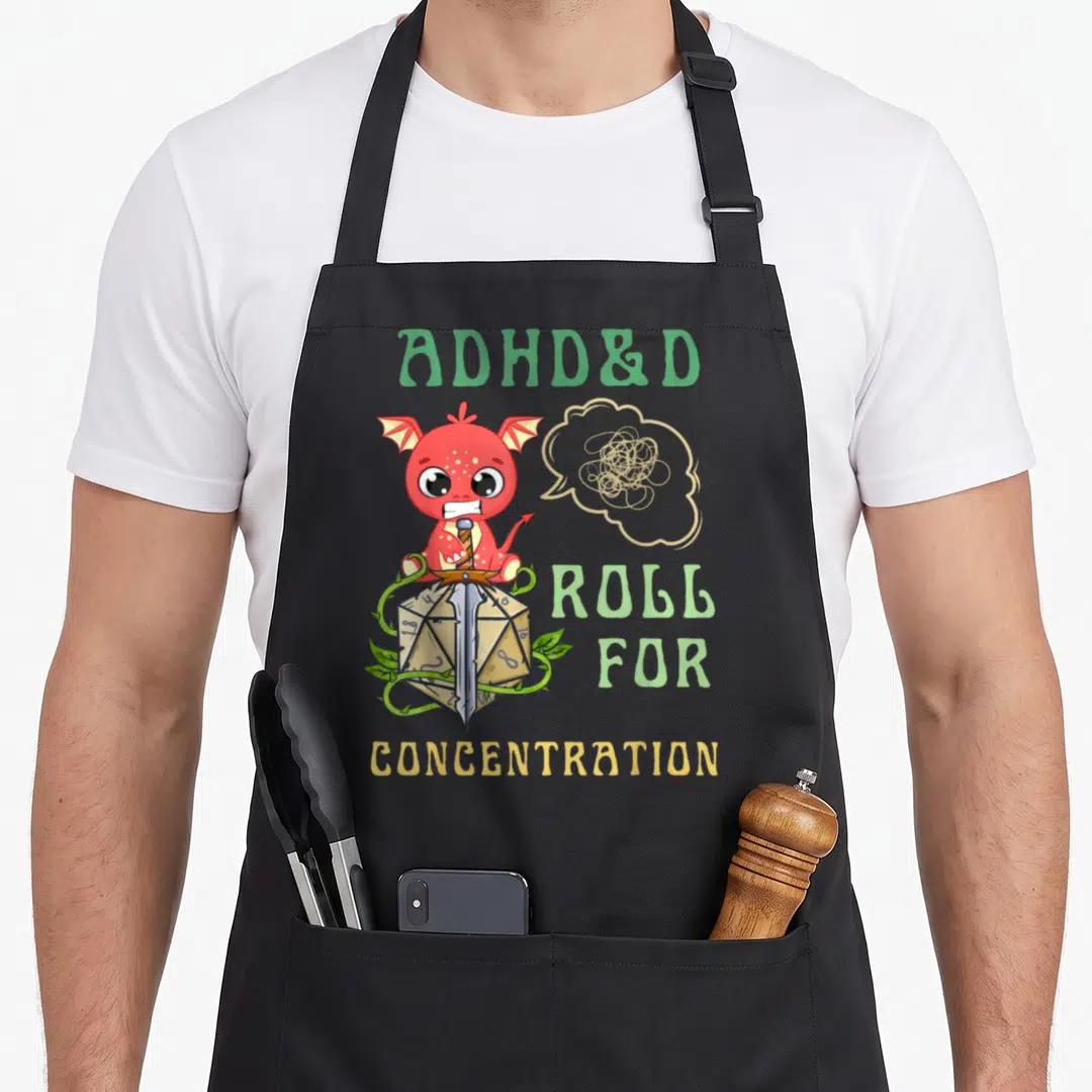 Adhd games quotes apron - Red dragon on d20 die with ADHD&D text and scribble bubble — shown on a black cotton canvas apron against a white background