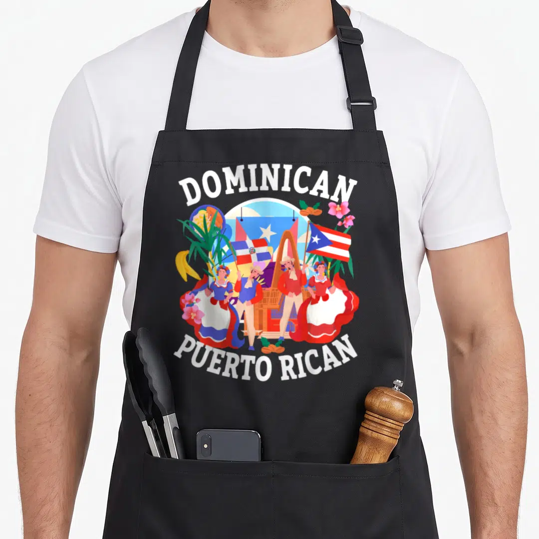 Dominican chef outfit with apron - Cartoon of Dominican and Puerto Rican dancers holding flags surrounded by tropical — shown on a black cotton canvas apron against a white background