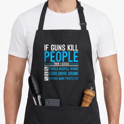 Kill gun apron - Stacked text about pencils cars and spoons with three small icons on black fabric — shown on a black cotton canvas apron against a white background