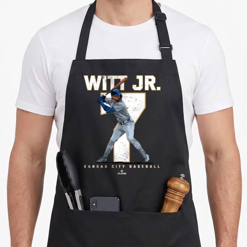 Number kansas girl apron - Distressed baseball player graphic with WITT JR. text and large number 7 in white blue — shown on a black cotton canvas apron against a white background