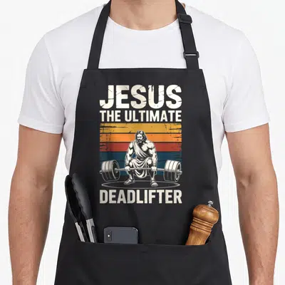 Funny jesus ultimate apron - Distressed JESUS THE ULTIMATE DEADLIFTER text around a barbell-lifting figure on a striped — shown on a black cotton canvas apron against a white background