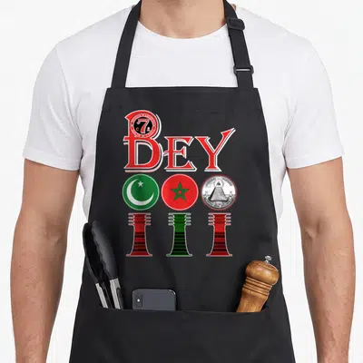 Crew native american apron - Red BEY text above three circles with crescent star pentagram and pyramid flanked — shown on a black cotton canvas apron against a white background