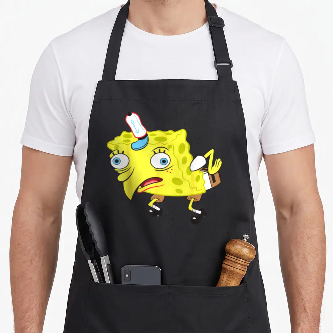 Even meme apron - SpongeBob SquarePants cartoon in yellow white brown black wearing small hat and high heels — shown on a black cotton canvas apron against a white background