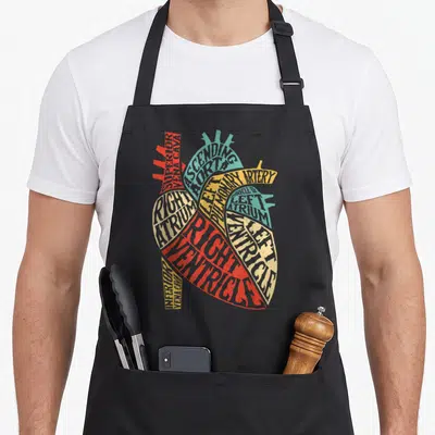 Typography science apron - Heart shape formed by red blue and yellow text labels of cardiac anatomy parts — shown on a black cotton canvas apron against a white background