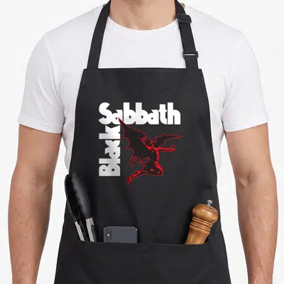 Demon black sabbath apron - White Sabbath and Black text with red outlined winged demon holding a star — shown on a black cotton canvas apron against a white background
