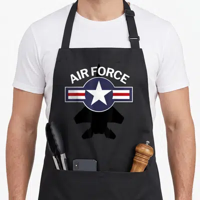 F15 air force apron - AIR FORCE text over blue roundel white star red stripes black jet silhouette — shown on a black cotton canvas apron against a white background