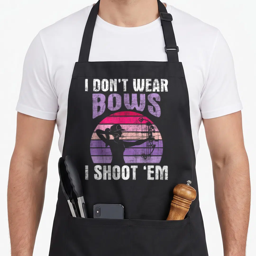 Bowman bow apron - Archer silhouette in striped gradient sun with pun text — shown on a black cotton canvas apron against a white background