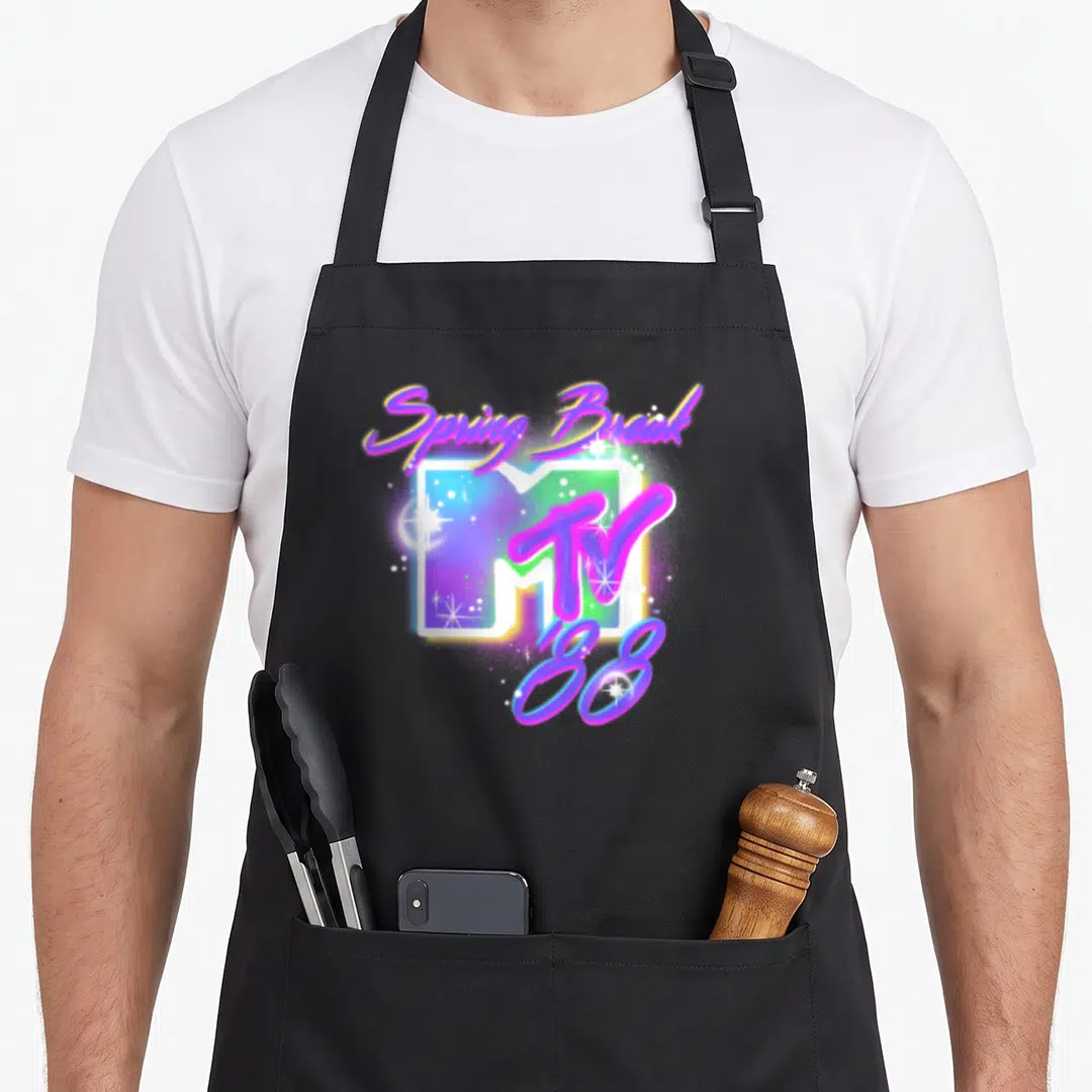 Airbrushed spring aprons - Retro MTV logo with arched Spring Break text and '88 in purple, blue, pink, and green — shown on a black cotton canvas apron against a white background