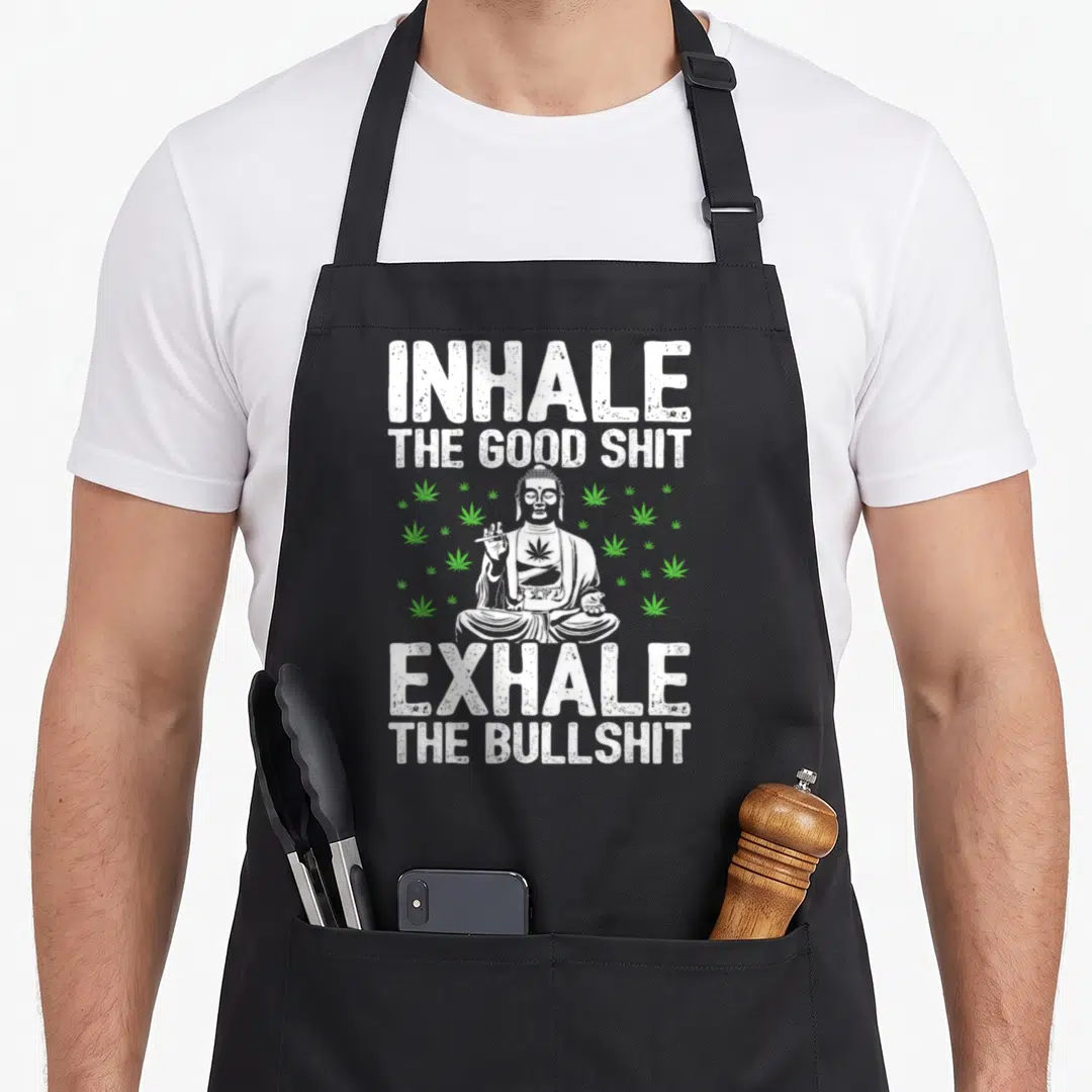 Inhale dump apron - Distressed white Buddha holding joint surrounded by green leaves with sarcastic text — shown on a black cotton canvas apron against a white background