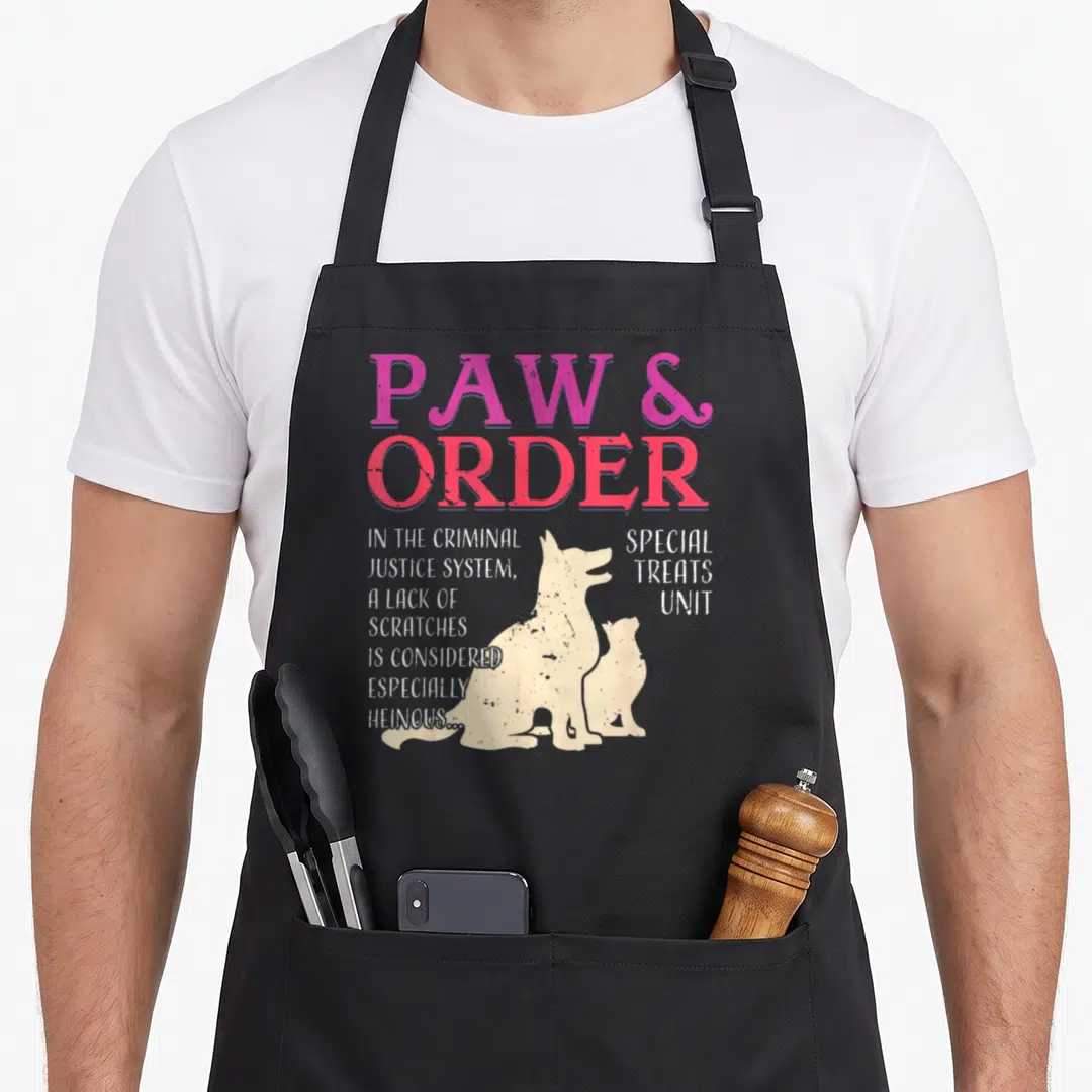 Special dog training apron - Paw and Order text with dog cat silhouettes and scratches quote — shown on a black cotton canvas apron against a white background