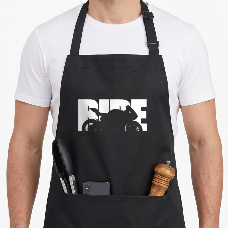 Bike motorcycle apron - White RIDE text with grey motorcycle silhouette cutout on black bib apron — shown on a black cotton canvas apron against a white background
