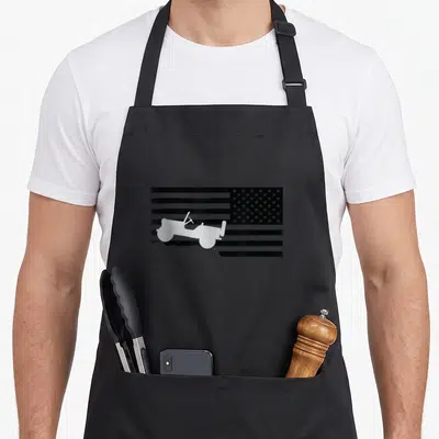 Funny jeep american flag apron - White jeep silhouette on black and white American flag background — shown on a black cotton canvas apron against a white background
