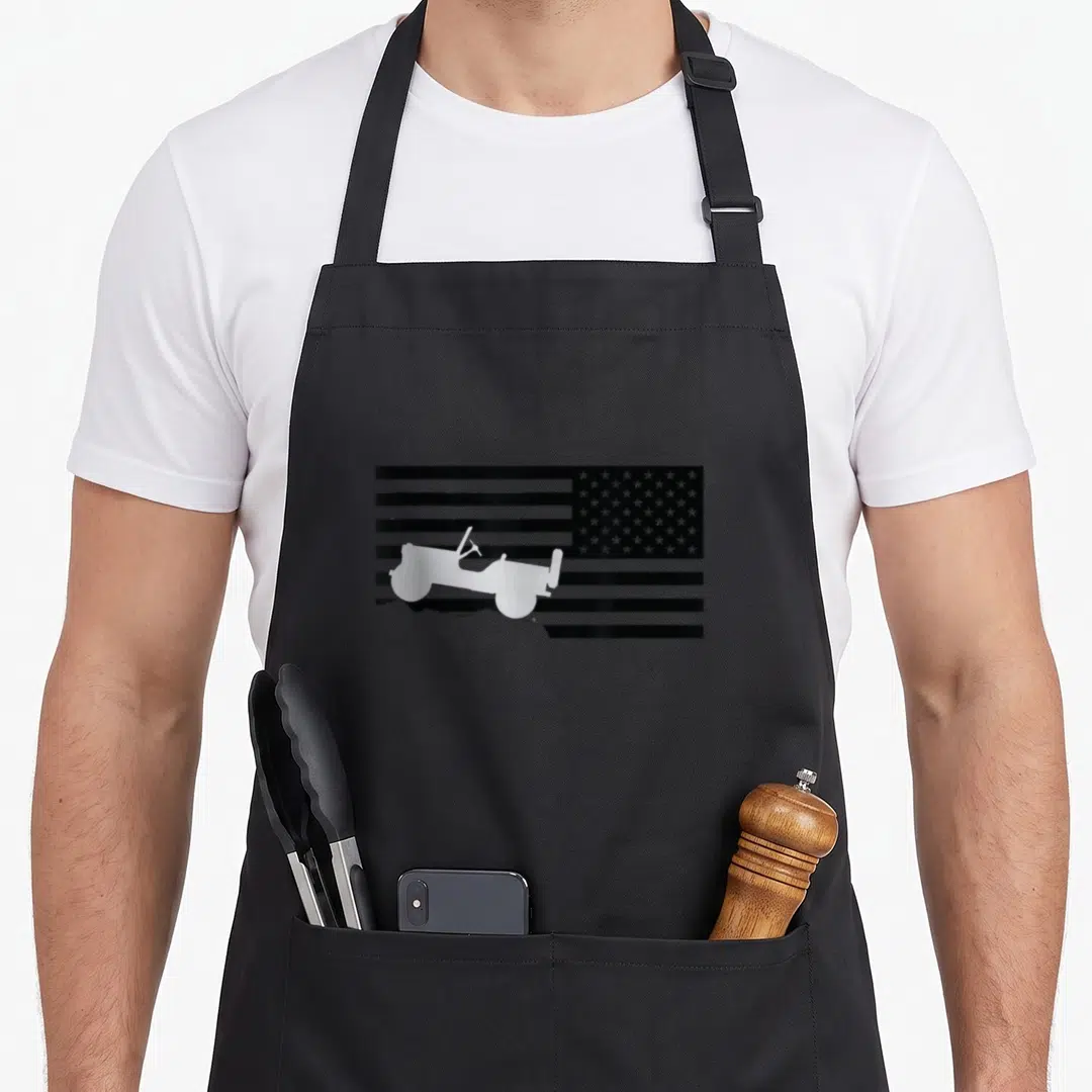 Funny jeep american flag apron - White jeep silhouette on black and white American flag background — shown on a black cotton canvas apron against a white background