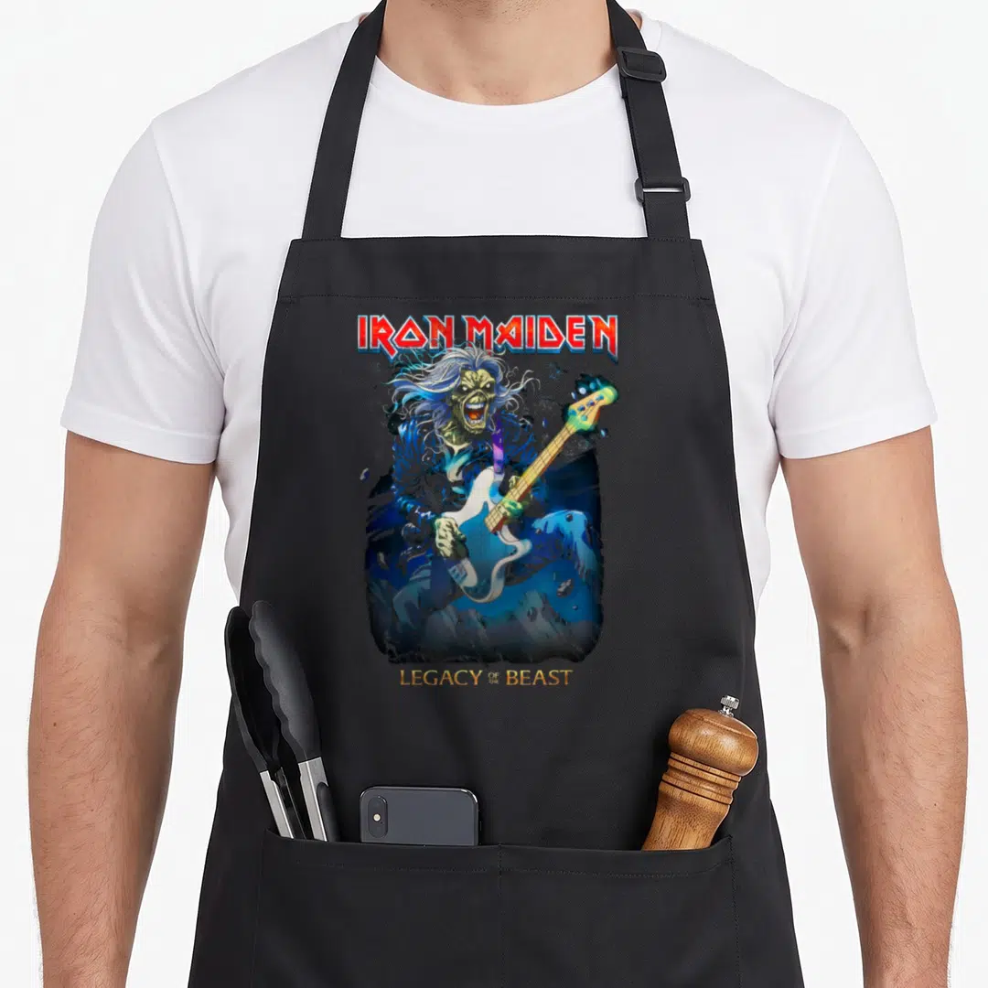 Eddie bass apron - Eddie playing blue guitar with Iron Maiden and Legacy of the Beast text — shown on a black cotton canvas apron against a white background