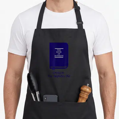Spoiler book of mormon apron - Dark blue book graphic with white text reading The Book of Mormon and Spoiler — shown on a black cotton canvas apron against a white background