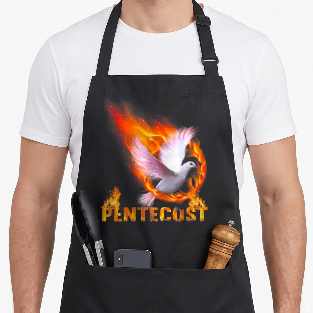 Pentecost catholic apron - White dove surrounded by fire ring with flame-textured PENTECOST lettering below — shown on a black cotton canvas apron against a white background
