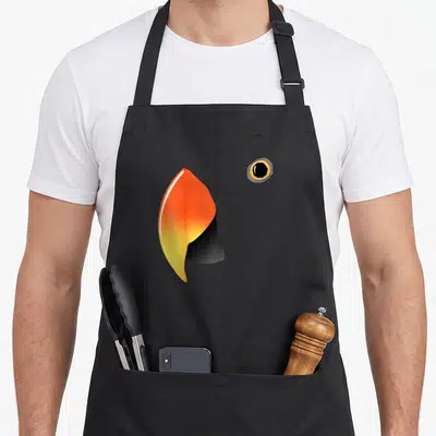 Eclectus parrot bird apron - Orange yellow black bird beak and eye minimalist print — shown on a black cotton canvas apron against a white background